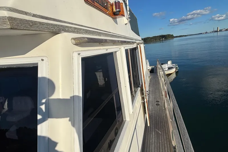 Slide: The Image of 1989 Grand Banks 46 Classic yacht on calm water, side view with clear sky. - 36