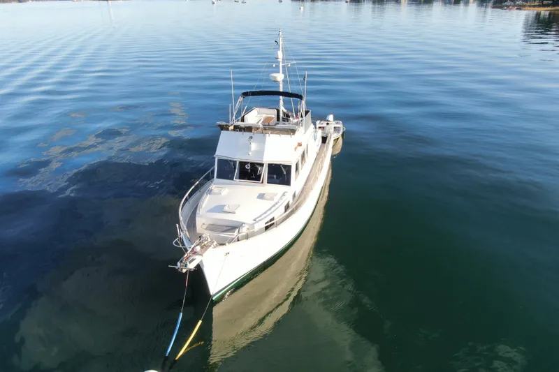 Slide: The Image of 1989 Grand Banks 46 Classic yacht on calm water, aerial view. - 4