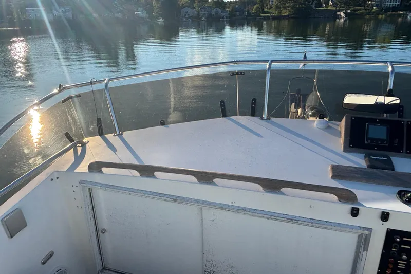 Slide: The Image of 1989 Grand Banks 46 Classic yacht deck with serene water view and sunlight reflections. - 50