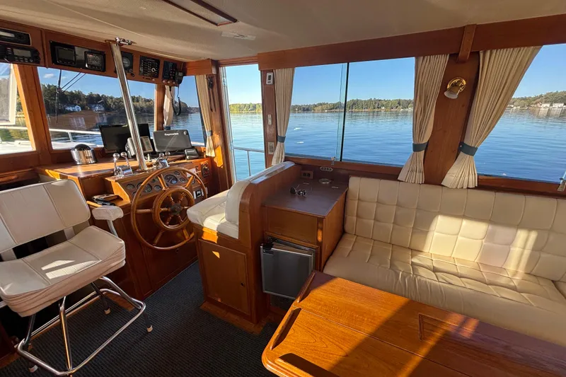 Slide: The Image of Interior of 1989 Grand Banks 46 Classic yacht with helm, seating, and scenic water view. - 65