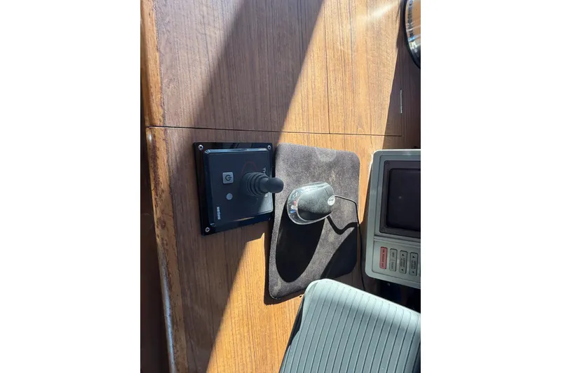 Slide: The Image of Control panel and joystick on 1989 Grand Banks 46 Classic yacht dashboard. - 75