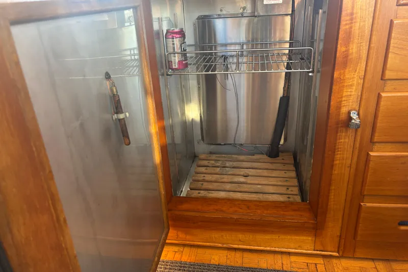 Slide: The Image of Open wooden cabinet on 1989 Grand Banks 46 Classic yacht, showing interior storage space. - 88