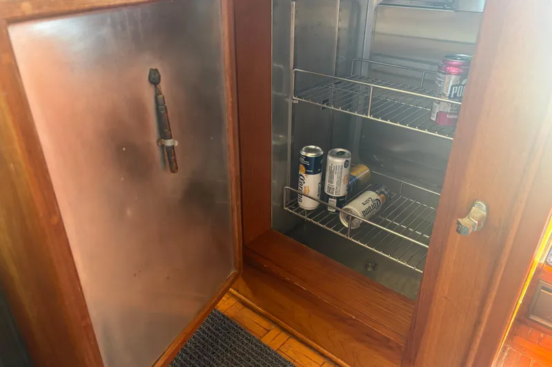 Slide: The Image of Open fridge on 1989 Grand Banks 46 Classic yacht with drinks inside. - 90