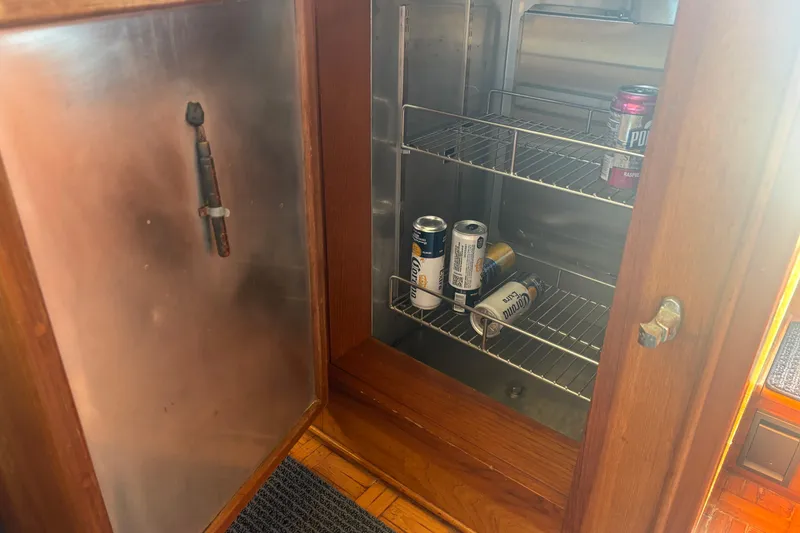 Slide: The Image of Open fridge on 1989 Grand Banks 46 Classic yacht with drinks inside. - 91