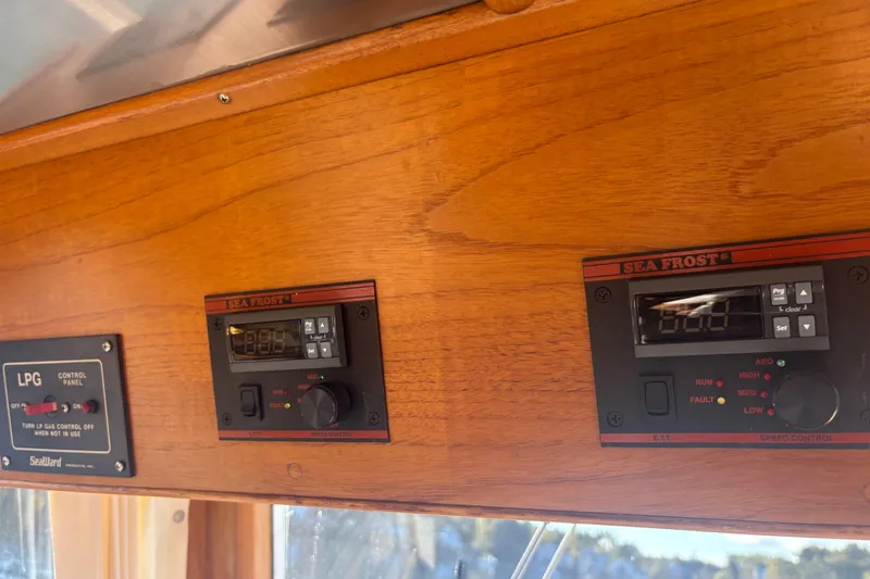 Slide: The Image of Control panels on 1989 Grand Banks 46 Classic yacht, featuring Sea Frost and LPG systems. - 92