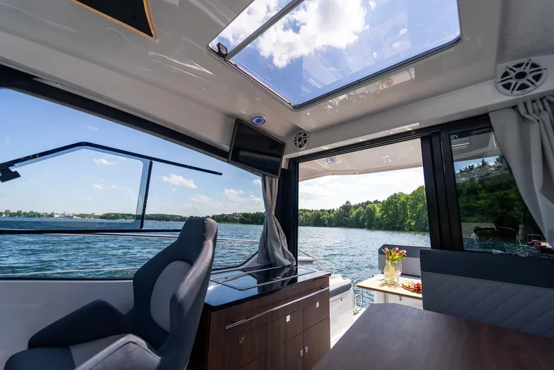 Slide: The Image of Interior of 2025 Nautic 880 boat, featuring cozy cabin with wood accents and ambient lighting. - 15
