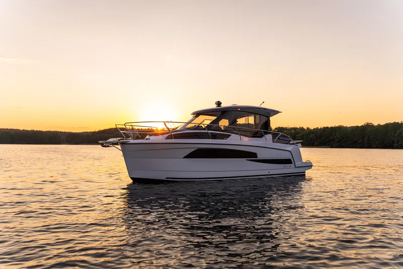 Slide: The Image of A Nautic 880 boat on a serene lake at sunset, 2025 model. - 3