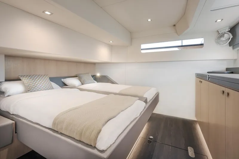 Slide: The Image of Luxury cabin interior of 2025 Privilege Signature 650 yacht with twin beds and modern decor. - 29