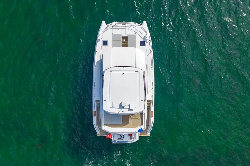 Slide: The Image of Aerial view of 2023 Leopard 46 Powercat yacht on green ocean water. - 10