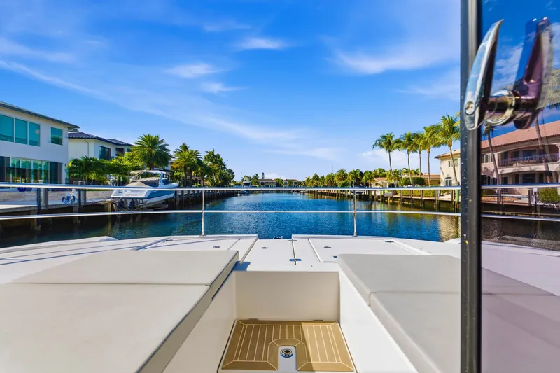 Slide: The Image of 2023 Leopard 46 Powercat on a scenic canal with palm trees and luxury homes. - 13