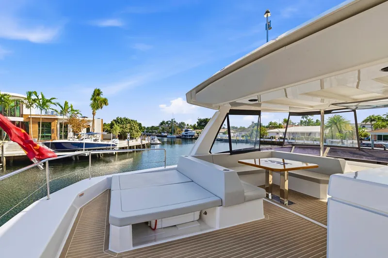 Slide: The Image of 2023 Leopard 46 Powercat yacht with spacious deck, docked in a scenic marina. - 19
