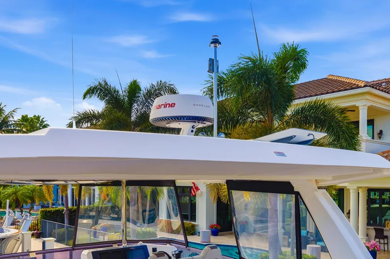 Slide: The Image of 2023 Leopard 46 Powercat yacht with radar, docked near tropical villa. - 20