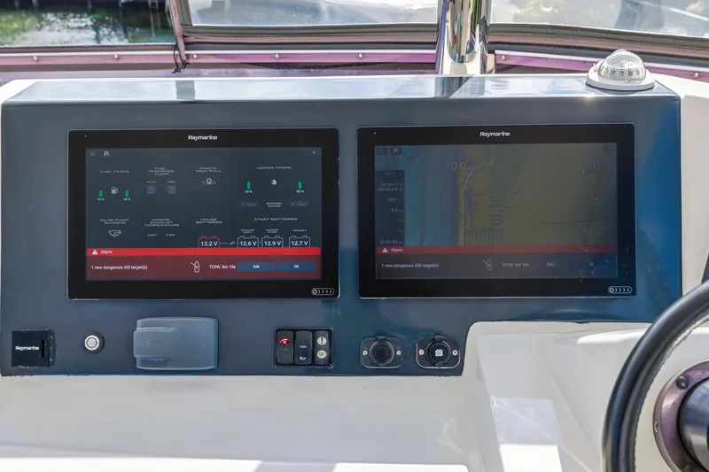Slide: The Image of Control panel of 2023 Leopard 46 Powercat with dual Raymarine displays. - 27