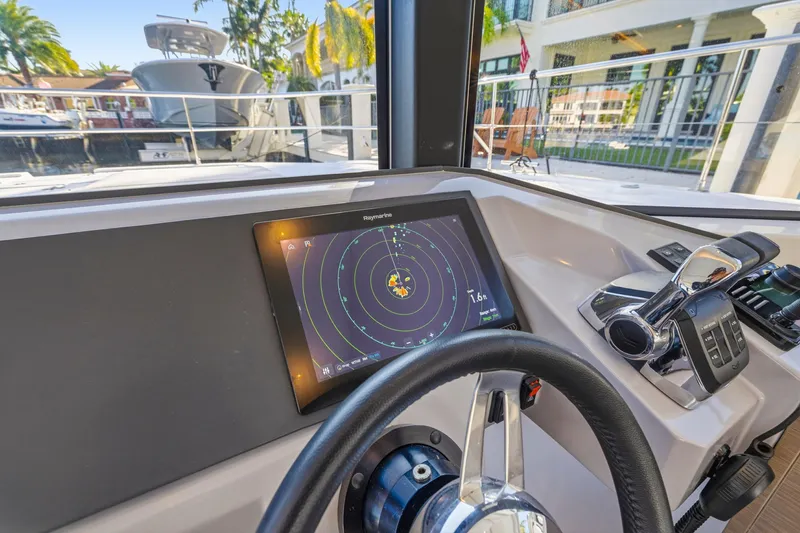 Slide: The Image of Helm of 2023 Leopard 46 Powercat with navigation display and controls. - 47