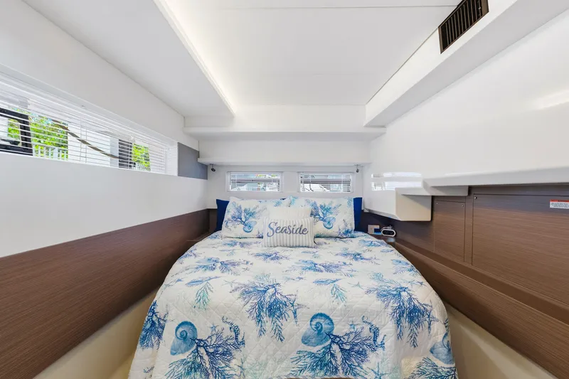 Slide: The Image of Luxurious bedroom interior of 2023 Leopard 46 Powercat with nautical-themed bedding. - 48