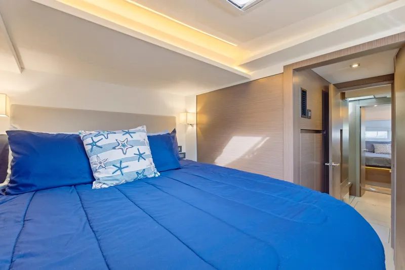 Slide: The Image of Luxurious bedroom interior of 2023 Leopard 46 Powercat with blue bedding and modern design. - 55