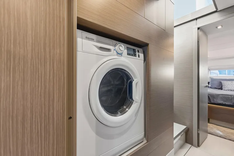 Slide: The Image of Laundry area in 2023 Leopard 46 Powercat yacht, featuring a built-in washing machine. - 58