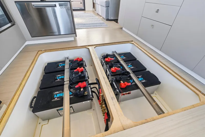 Slide: The Image of 2023 Leopard 46 Powercat battery compartment with multiple batteries and modern kitchen appliances. - 64