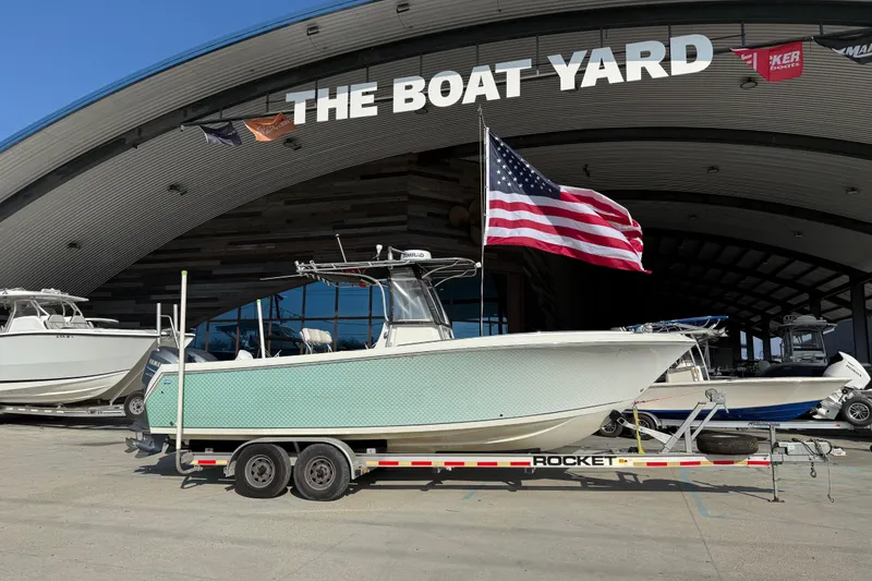The Image of 2007 Sailfish 2660 CC boat on trailer at The Boat Yard, American flag displayed. - 1