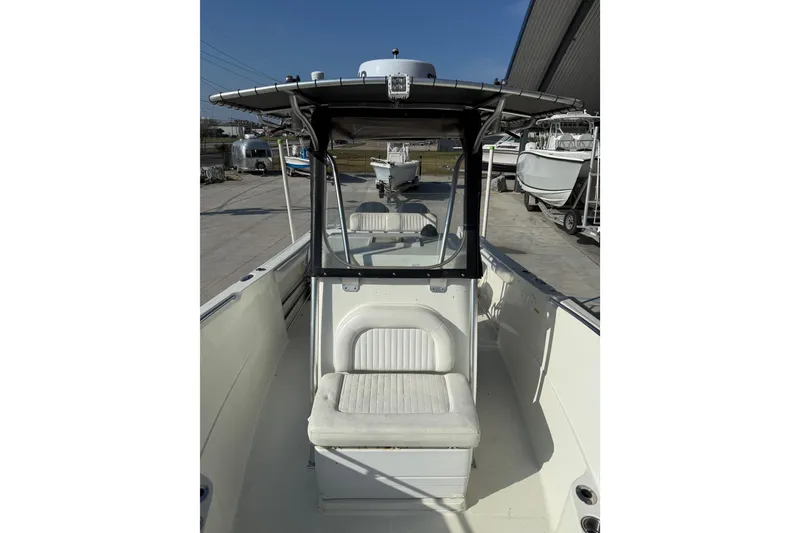 Slide: The Image of 2007 Sailfish 2660 CC boat with center console and seating, docked outdoors. - 11