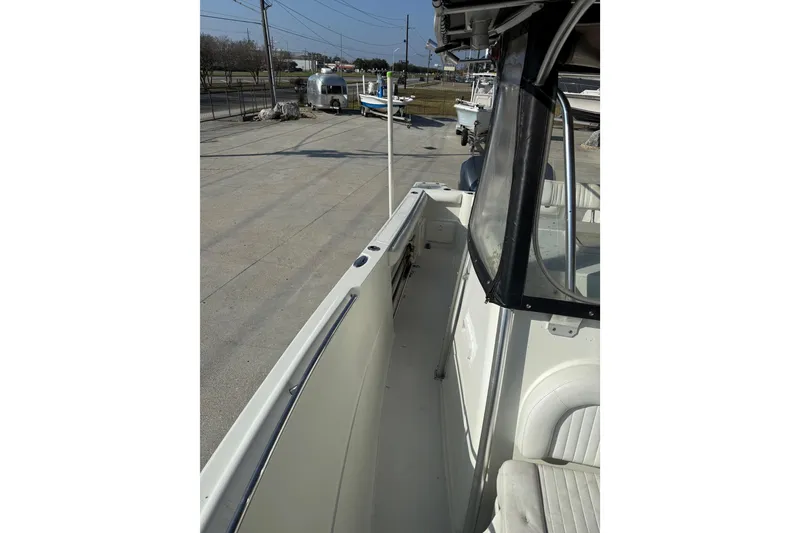 Slide: The Image of 2007 Sailfish 2660 CC boat deck view, showcasing seating and railing. - 12