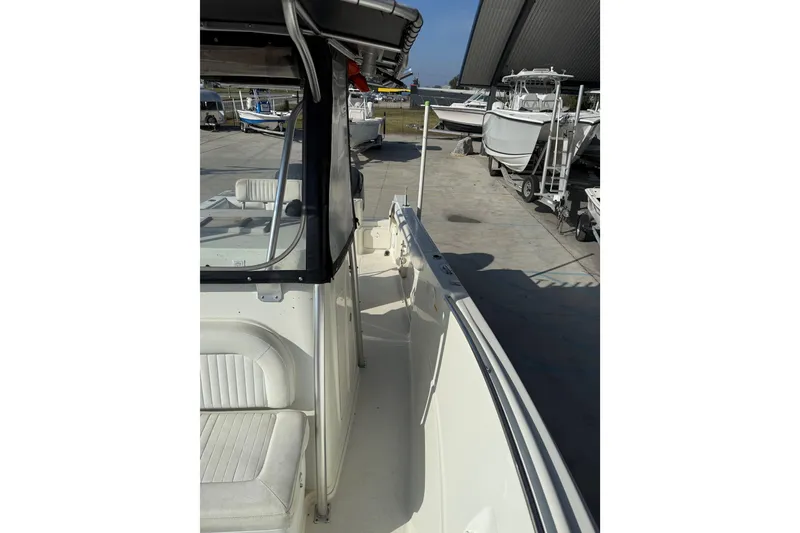 Slide: The Image of 2007 Sailfish 2660 CC boat docked, featuring seating and console area. - 13