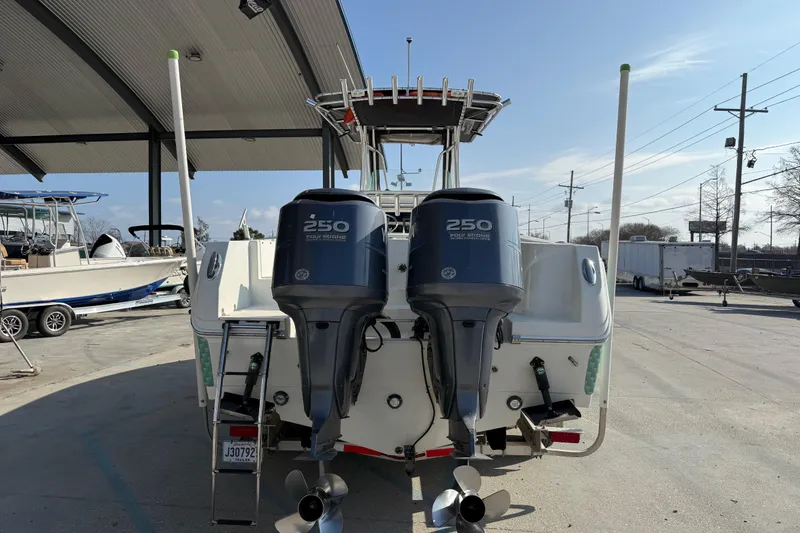 Slide: The Image of 2007 Sailfish 2660 CC boat with twin 250 horsepower outboard engines at a marina. - 3