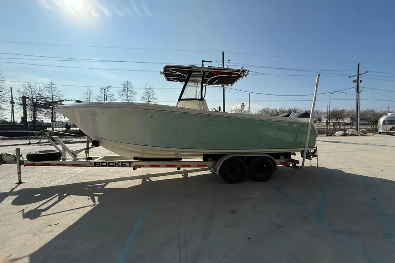 Slide: The Image of 2007 Sailfish 2660 CC boat on trailer under clear blue sky. - 5