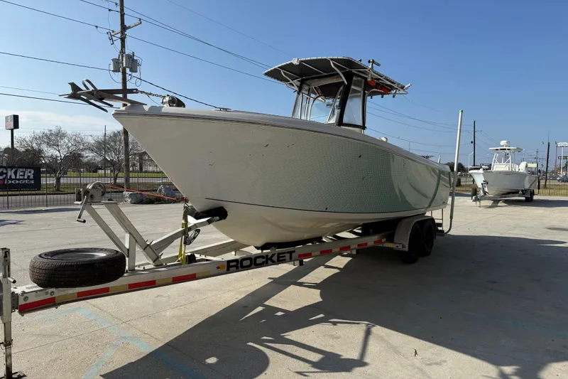 Slide: The Image of 2007 Sailfish 2660 CC boat on trailer in sunny outdoor setting. - 6