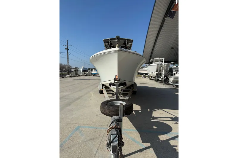 Slide: The Image of 2007 Sailfish 2660 CC boat on trailer, parked outdoors under clear blue sky. - 7