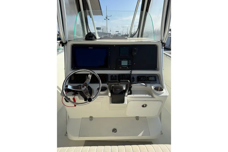 Slide: The Image of 2007 Sailfish 2660 CC boat console with steering wheel and navigation equipment. - 8