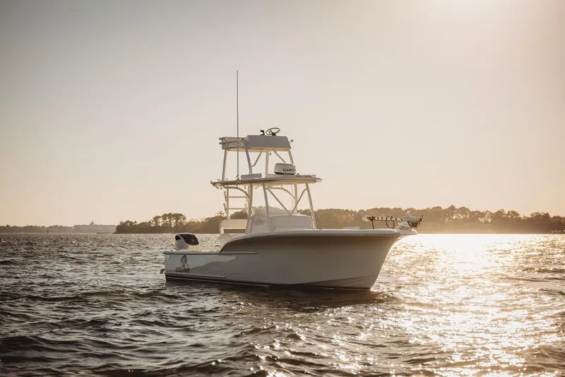 Slide: The Image of 2026 Composite Yacht 26CC on sunlit water, showcasing sleek design and modern features. - 3