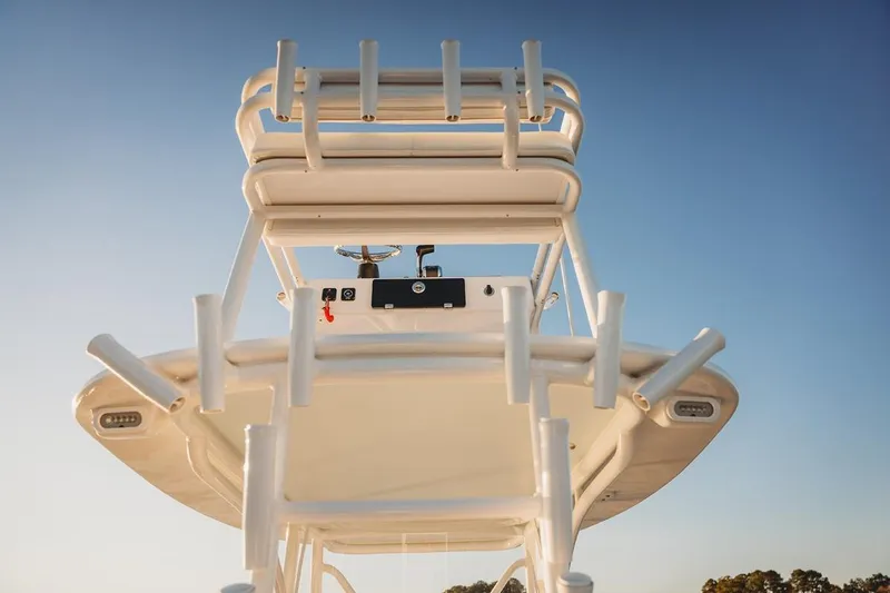 Slide: The Image of 2026 Composite Yacht 26CC, view of upper deck and rod holders against clear sky. - 5