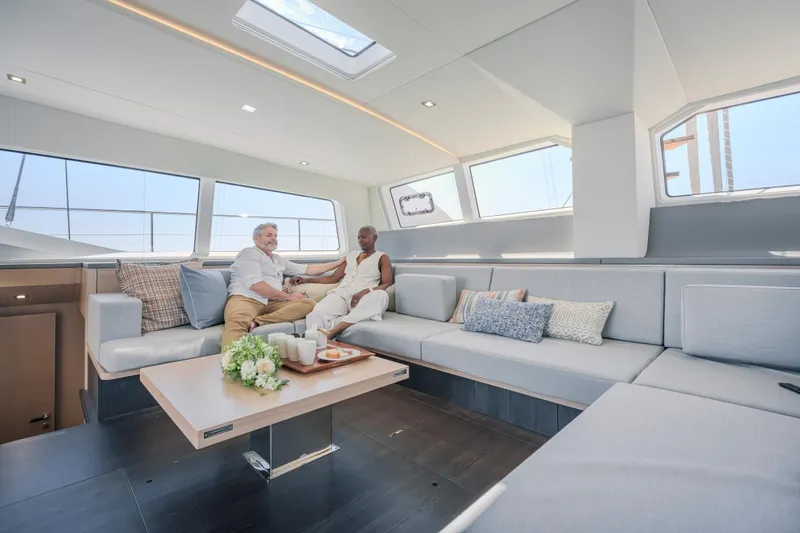 Slide: The Image of Luxurious interior of 2025 Privilege Signature 650 yacht with two people relaxing on a sofa. - 15