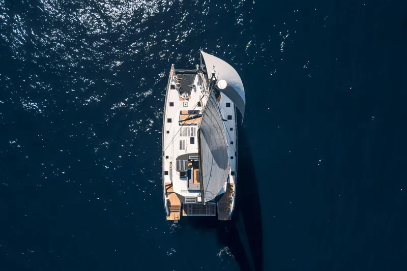 Slide: The Image of Aerial view of 2025 Privilege Signature 650 yacht sailing on deep blue ocean. - 44