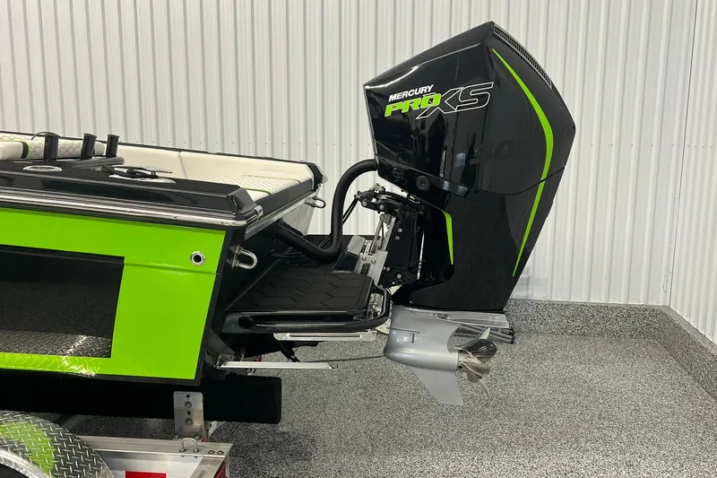Slide: The Image of 2024 Action 23 Open boat with Mercury Pro XS outboard motor, green and black design. - 7