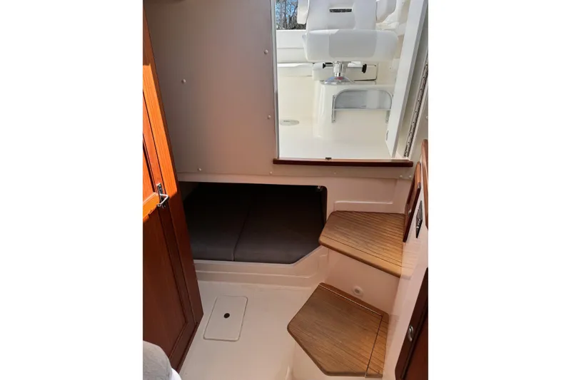 Slide: The Image of 2024 NorthCoast 285 HT cabin interior with wooden steps and seating area. - 12