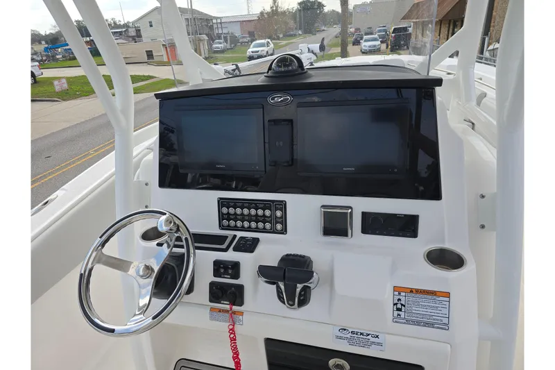 Slide: The Image of 2023 Sea Fox 288 Commander dashboard with steering wheel and electronic displays. - 14