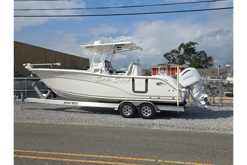 Slide: The Image of 2023 Sea Fox 288 Commander boat on trailer, parked outdoors under a cloudy sky. - 3