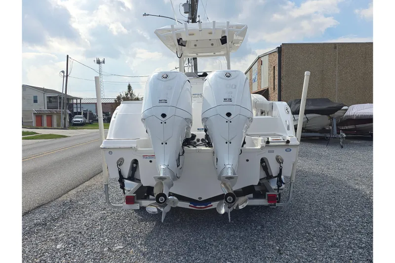 Slide: The Image of 2023 Sea Fox 288 Commander boat with dual outboard engines, parked on gravel. - 5