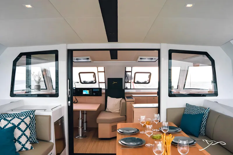 Slide: The Image of Interior of 2025 Nautitech 40 Open catamaran, featuring modern dining and navigation areas. - 27