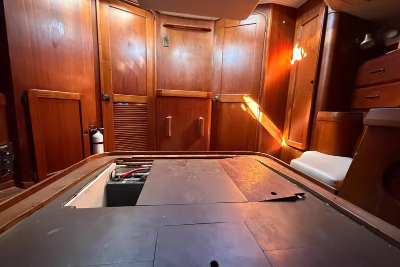 Slide: The Image of Interior of 1983 Morgan Catilina sailboat with wooden paneling and storage compartments. - 101