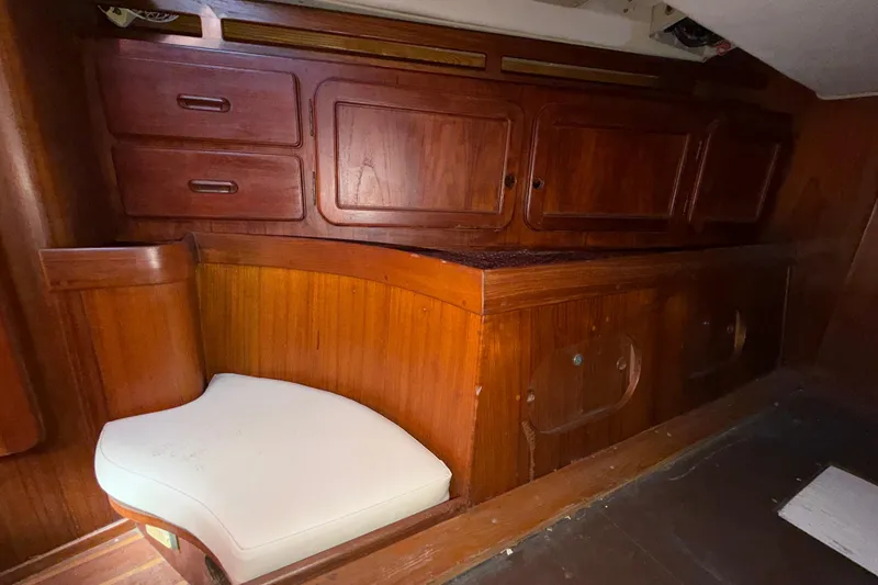 Slide: The Image of 1983 Morgan Catilina interior with wooden cabinetry and white cushioned seating. - 103