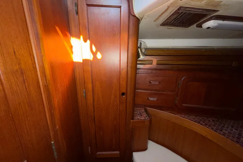 Slide: The Image of 1983 Morgan Catilina interior with wooden cabinetry and sunlight reflection. - 104