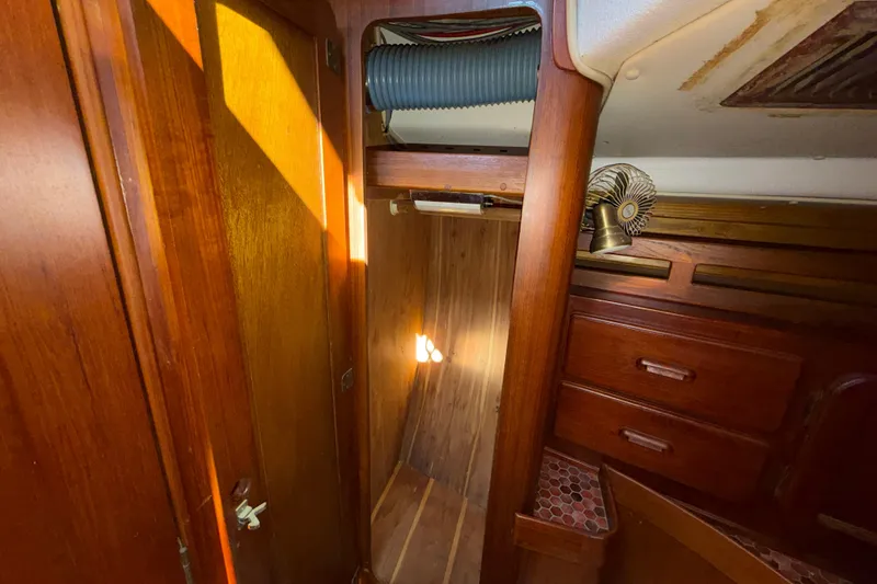 Slide: The Image of Interior of 1983 Morgan Catilina sailboat with wooden cabinetry and storage space. - 105