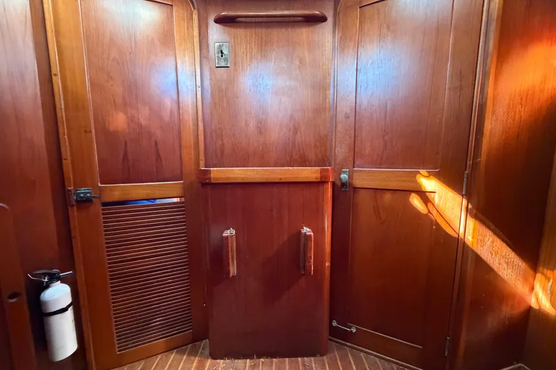 Slide: The Image of 1983 Morgan Catilina interior with wooden paneling and a fire extinguisher. - 106
