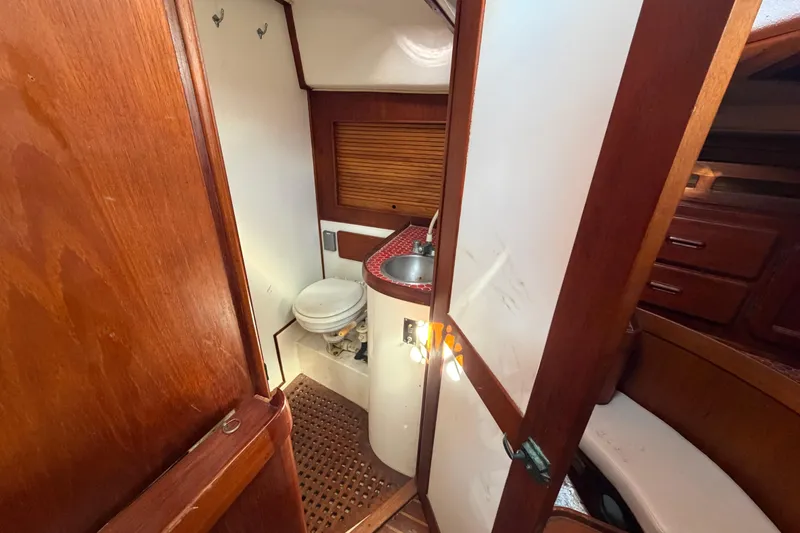 Slide: The Image of 1983 Morgan Catilina yacht bathroom with wooden interior and compact sink. - 107