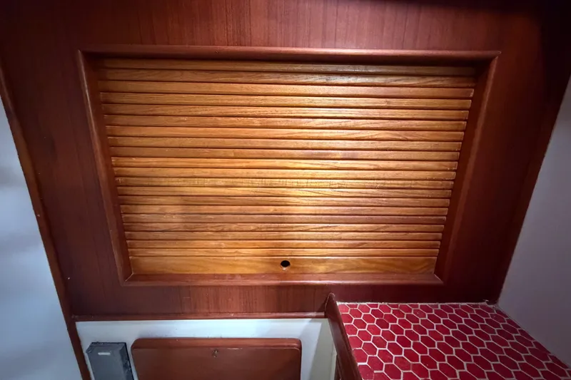 Slide: The Image of Wooden louvered cabinet door in 1983 Morgan Catilina interior, with red hexagonal tile surface. - 111
