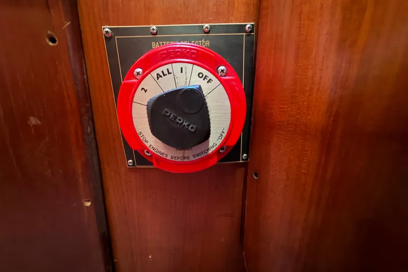 Slide: The Image of Red Perko battery selector switch on 1983 Morgan Catilina boat's wooden panel. - 119