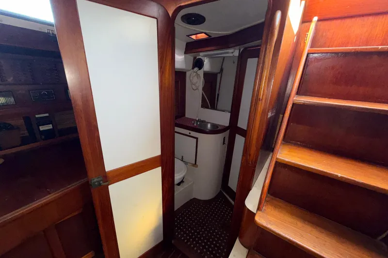 Slide: The Image of Interior of 1983 Morgan Catilina yacht with wooden stairs and compact bathroom. - 121